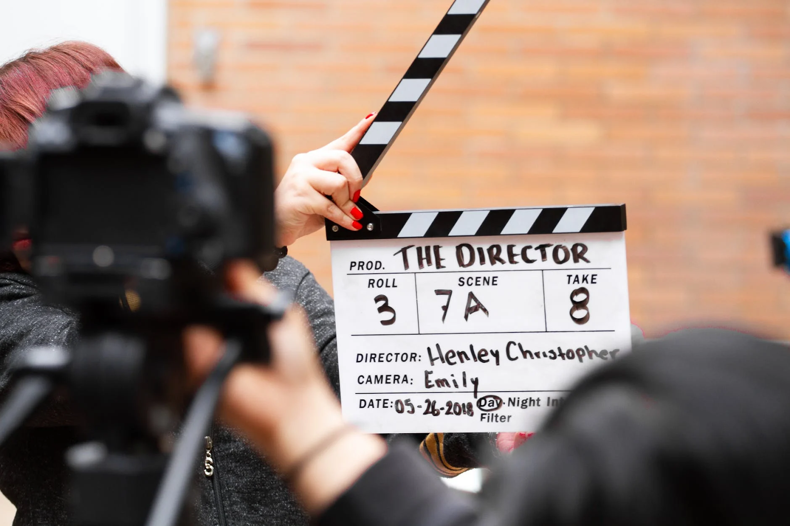 image of a man holding a clapper board